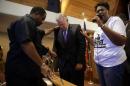 Missouri Gov. Jay Nixon, center, prays during a meeting of clergy and community members held to discuss law enforcement's response to demonstrations over the killing of Michael Brown, Thursday, Aug. 14, 2014, in Florissant, Mo. Nixon says "operational shifts" are ahead for law enforcement in the St. Louis suburb where a police officer fatally shot an unarmed black teenager. (AP Photo/Jeff Roberson)