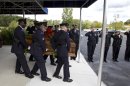Washington D.C. metropolitan police officers carries the coffin of Richard Michael Ridgell, 52, of Westminster, Md. after his funeral service at the at The Church at Severn Run, in Severn, Md., on Saturday, Sept. 28, 2013. Ridgell was one of the 12 victims who died during Washington Navy Yard shootings. ( AP Photo/Jose Luis Magana)