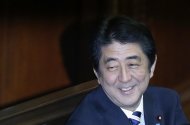 Japan's Prime Minister Shinzo Abe smiles during the Lower House plenary session of the parliament in Tokyo November 26, 2013. REUTERS/Toru Hanai
