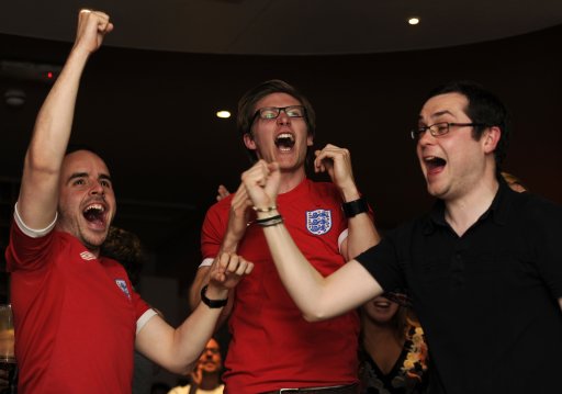 England fans react while watching England's EURO 2012 soccer match against Ukraine at a pub in London