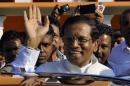 Presidential candidate Sirisena waves at his supporters as he leaves after casting his vote for the presidential election, in Polonnaruwa