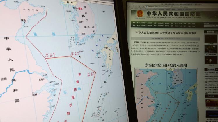 Computer screens display a map showing the outline of China's new air defense zone in the East China on the website of the Chinese Ministry of Defense, in Beijing Tuesday, Nov. 26, 2013. Beijing on Saturday, Nov. 23, 2013 issued a map of the zone - which includes a cluster of islands controlled by Japan but also claimed by China - and a set of rules that say all aircraft entering the area must notify Chinese authorities and are subject to emergency military measures if they do not identify themselves or obey Beijing's orders. Chinese characters in red in the center of the map at left reads: "Air Defense Identification Zone in East China Sea." (AP Photo/Ng Han Guan)