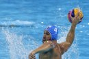 Pietro Figlioli of Italy shoots and scores a penalty goal against Spain during the men's water polo preliminary round match at the 2012 Summer Olympics, Monday, Aug. 6, 2012, in London. (AP Photo/Alastair Grant)