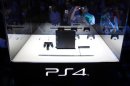 Visitors take pictures of Sony Corp's PlayStation 4 new game console at the Tokyo Game Show in Chiba