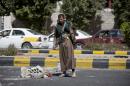 A Houthi Shiite Yemeni stands guard at a street leading to the presidential palace in Sanaa, Yemen, Wednesday, Jan. 21, 2015. Authorities in southern Yemen have closed the country's second-largest airport there in protest over the Shiite rebels' power grab in the capital, Sanaa, which has plunged the nation deeper into chaos and threatens to fracture the country. (AP Photo/Hani Mohammed)