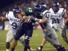 FILE - In this Oct. 9, 2004, file photo, Hawaii's Bryan Maneafaiga (43) scores a touchdown against Nevada in Honolulu. With uneven testing for steroids and inconsistent punishment, college football players are packing on significant weight _ in some cases, 30 pounds or more in a single year _ without drawing much attention from their schools or the NCAA in a sport that earns tens of billions of dollars for teams. But looking solely at the most significant weight gainers also ignores players like Maneafaiga. In the summer of 2004, Maneafaiga was an undersized 180-pound running back trying to make the University of Hawaii football team. Twice, once in pre-season and once in the fall, he failed school drug tests, showing up positive for marijuana use. What surprised him was that the same tests turned up negative for steroids. He’d started injecting stanozolol, a steroid, in the summer to help bulk up to a roster weight of 200 pounds. (AP Photo/ Honolulu Star-Advertiser, George F. Lee)