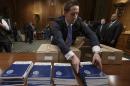 Copies of President Barack Obama's proposed budget are set out for distribution by Senate Budget Committee Clerk Adam Kamp, on Capitol Hill in Washington, Tuesday, March 4, 2014. (AP Photo/J. Scott Applewhite)