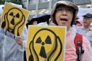 People shout slogans during a demonstration denouncing nuclear power plants in Tokyo