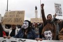 Demonstrators shout while taking part in a march against government austerity policies in Lisbon