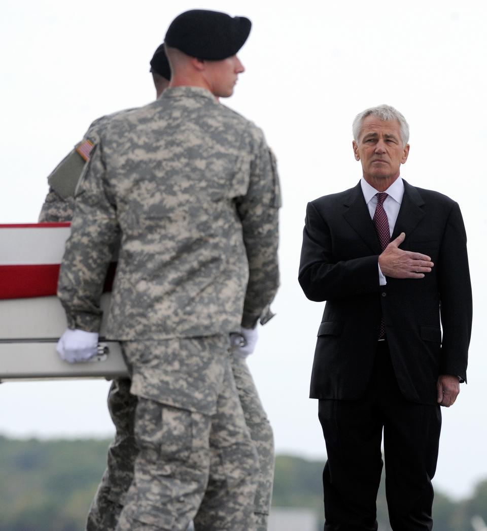 Defense Secretary Chuck Hagel, right, watches an Army carry team move a transfer case containing the remains of Pfc. Cody J. Patterson Wednesday, Oct. 9, 2013 at Dover Air Force Base, Del. According to the Department of Defense, Patterson, 24, of Philomath, Ore., died Oct. 6, 2013 in Zhari district, Afghanistan of injuries sustained when enemy forces attacked his unit with an improvised explosive device. (AP Photo/Steve Ruark)
