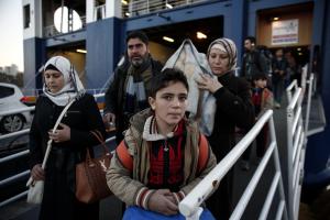 Migrants and refugees disembark from a ferry after&nbsp;&hellip;