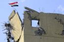 An Iraqi flag flutters at the roof of a hospital damaged by clashes during a battle between Iraqi forces and Islamic State militants in the Wahda district of eastern Mosul, Iraq