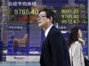 People walk by an electronic stock board of a securities firm in Tokyo, Thursday, Dec. 13, 2012. Asian stock markets rose Thursday with the help of Japan's Nikkei 225, which was propelled higher by a weakening yen. (AP Photo/Koji Sasahara)