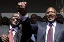 President-elect Kenyatta greets his supporters with his running mate Ruto after attending a news conference in Nairobi