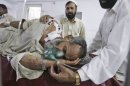 A man who was injured in a suicide bombing in the tribal region of Khar in Bajur, is comforted by relatives, in a hospital in Peshawar, Pakistan, Friday, May 4, 2012. A suicide bombing in a Pakistani market close to the Afghan border killed 20 people Friday, officials said, a day after the U.S. released letters seized from Osama bin Laden's compound that criticized Pakistani militants for killing too many civilians. (AP Photo/Mohammad Sajjad)