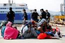 Migrants rests after disembarking from Dignity ship in the Sicilian harbour of Augusta