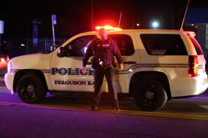 A Ferguson police officer stands on West Florissant &hellip;
