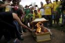 Demonstrators burn a coffin that represent Brazil's President Rousseff during a protest calling for the impeachment of Rousseff in front of the National Congress in Brasilia