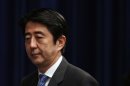 File picture shows then Japanese Prime Minister Shinzo Abe arriving at a news conference in Tokyo