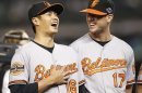 Baltimore Orioles starting pitchers Chen Wei-Yin and Brian Matusz laugh before Game 3 of their MLB ALDS baseball playoff series against the New York Yankees in New York