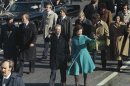 FILE - This Jan. 20, 1977 file photo shows President Jimmy Carter and First Lady Rosalynn Carter waving as they walk down Pennsylvania Avenue in Washington after Carter was sworn in as the nation's 39th president. At some point on Inauguration Day, if all goes expected, the president's limousine will slow to a stop on its journey down Pennsylvania Avenue from the Capitol to the White House. A Secret Service agent will open the rear passenger door, and the newly sworn-in president will emerge from his car for a several-minute stroll. The crowd will cheer. The president will wave. In that moment, Pennsylvania Avenue is America's red carpet. And the president is the only celebrity on it. The victory walk has become an iconic inaugural moment, one expected by the public and the press. And though the tradition dates only to President Jimmy Carter, it has already developed an air of inevitability and predictable patterns. (AP Photo, File)