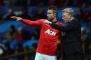 Manchester United's Scottish manager David Moyes (R) gives instructions to Dutch striker Robin van Persie at Old Trafford in Manchester, northwest England on December 10, 2013