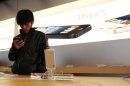A visitor tries an iPhone at an Apple store in Beijing