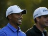 Woods of the U.S. smiles as he and compatriot Bradley walk off the 11th tee during a practice round in preparation for the 2013 Masters golf tournament in Augusta