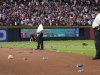 Atlanta Braves officials pick up trash on the field as security stand by during the eighth inning of the National League wild card playoff baseball game against the St. Louis Cardinals, Friday, Oct. 5, 2012, in Atlanta. The Cardinals won baseball's first wild-card playoff, taking advantage of a disputed infield fly call that led to a protest and fans littering the field with debris to defeat the Braves 6-3. (AP Photo/Todd Kirkland)
