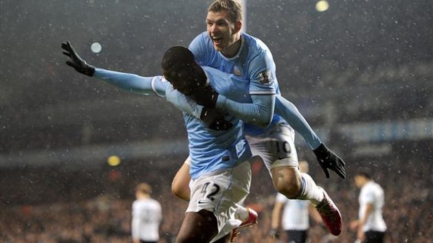 Manchester City's Yaya Toure celebrates with his team-mates after scoring his team's third goal