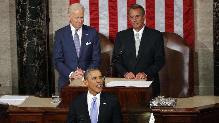 President Barack Obama takes the podium to give his State of the Union address on Capitol Hill in Washington, Tuesday Jan. 28, 2014. Vice President Joe Biden and House Speaker John Boehner of Ohio are behind the president. (AP Photo/Charles Dharapak)