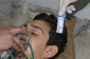 A man, affected by what activists say is nerve gas, breathes through an oxygen mask in Damascus suburbs