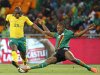Zambia's Stoppila Sunzu challenges Tokelo Rantie of South Africa during the Nelson Mandela Challenge at Soccer city outside Soweto