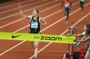 Galen Rupp celebrates as he breaks his own American record in the 10,000 meters finishing in 26 minutes, 44.36 seconds during "Distance Night in Eugene" at the Prefontaine Classic at Hayward Field in Eugene, Ore. on Friday, May 30, 2014. (AP Photo/The Register-Guard, Brian Davies)