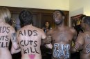 Naked AIDS activists, with painted slogans on their bodies, protest inside the lobby of the Capitol Hill office of House Speaker John Boehner of Ohio, Tuesday, Nov. 27, 2012, prior to World AIDS Day, Dec. 1. Three women AIDS activists saying they wanted to highlight the â€œnaked truthâ€ about potential spending cuts in HIV programs were arrested after taking their clothes off in the lobby Boehner's office. (AP Photo/Susan Walsh)