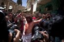 A Christian pilgrim dressed as Jesus Christ is attached to a cross during a reenactment of the crucifixion during a Good Friday procession in Jerusalem's Old City, Friday, March 29, 2013. Less than 2 percent of the population of Israel and the Palestinian territories is Christian, mostly split between Catholicism and Orthodox streams of Christianity. Christians in the West Bank wanting to attend services in Jerusalem must obtain permission from Israeli authorities. Israel's Tourism Ministry said it expects some 150,000 visitors in Israel during Easter week and the Jewish festival of Passover, which coincide this year. (AP Photo/Sebastian Scheiner)