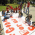 FILE - In this Sept. 19, 2012 file photo, Kountze High School cheerleaders and other children work on a large banner in Kountze, Texas. A judge on Wednesday, May 9, 2013 ruled that cheerleaders at the high school can display banners emblazoned with Bible verses at football games. The dispute began during the last football season when the district barred cheerleaders from using run-through banners that displayed religious messages, such as "If God is for us, who can be against us." (AP Photo/The Beaumont Enterprise, Dave Ryan, File)