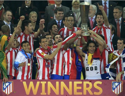 Atletico Madrid players celebrate with trophy after defeating Athletic Bilbao to win Europa League final soccer match in Bucharest