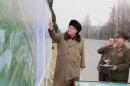 Picture released from North Korea's official Korean Central News Agency (KCNA) shows North Korean leader Kim Jong-Un (L) guiding the construction of Ryomyong Street in Pyongyang