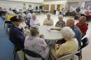 In this Wednesday, Sept. 10, 2014 photo, a group of retired senior citizens gather for cards at the Citrus County Resource Center in Lecanto, Fla. In Citrus County, more than a third of residents are senior citizens, the sixth-highest rate in the nation. (AP Photo/John Raoux)