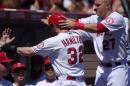 Los Angeles Angels' Josh Hamilton, center, has his helmet taken off by Mike Trout after scoring on a single by Erick Aybar during the second inning of a baseball game against the Oakland Athletics, Sunday, Aug. 31, 2014, in Anaheim, Calif. (AP Photo/Mark J. Terrill)
