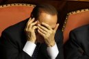People of Freedom party leader Silvio Berlusconi covers his face as he speaks on a mobile phone after delivering his speech at the Senate, in Rome, Wednesday, Oct. 2, 2013. Berlusconi acknowledged defeat Wednesday and announced he would support the government of Premier Enrico Letta, a stunning about-face on the Senate floor after defections in his party robbed him of the backing he needed to bring down the left-right coalition government. It was a major setback for Berlusconi, who had demanded his five Cabinet ministers quit the government and bring it down, incensed at a vote planned Friday that could strip him of his Senate seat following his tax fraud conviction and four-year prison sentence. (AP Photo/Gregorio Borgia)