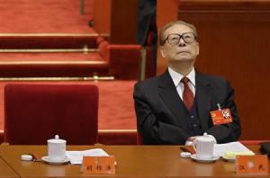 China's former President Jiang looks up while President Hu Jintao gives his speech during the opening ceremony of 18th National Congress of the Communist Party of China at the Great Hall of the People in Beijing