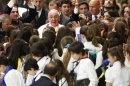 Pope Francis is surrounded by children during a special audience at the Vatican