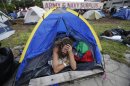 A demonstrator prepares to leave his tent, Tuesday, Aug. 28, 2012, in Tampa, Fla. Protestors gathered in a camp called "Romneyville," in Tampa to march in demonstration against the Republican National Convention. (AP Photo/Dave Martin)
