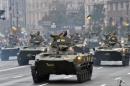 Armoured personnel carriers drive during a military parade in Kiev on August 24, 2016