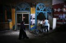 An Egyptian woman walks past posters of Egyptian presidential candidate for the upcoming elections Hamdeen Sabahi at a market in Cairo, Egypt, Wednesday, May 16, 2012. Egypt's military ruler says the country's upcoming presidential election will be a 