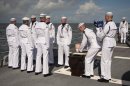U.S. Navy personnel carry the remains of Apollo 11 astronaut Neil Armstrong during a burial at sea service aboard the USS Philippine Sea (CG 58), Friday, Sept. 14, 2012, in the Atlantic Ocean. Armstrong, who died last month in Ohio at age 82, walked on the moon in July 1969. (AP Photo/NASA, Bill Ingalls)