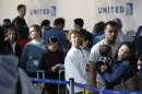 Passengers wait in line to rebook cancelled flights at O'Hare International Airport in Chicago