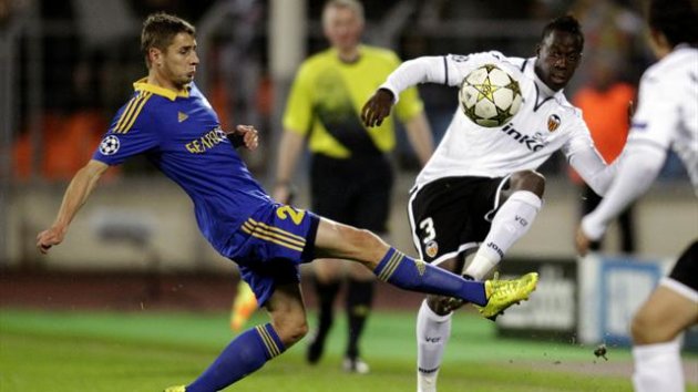 BATE Borisov's Dmitri Likhtarovich (L) fights for the ball with Valencia's Aly Cissokho during their Champions League Group F match